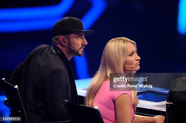 Jury members Mirko Bogojevic and Sarah Connor listen to a performance during 'The X Factor Live' TV-Show on November 15, 2011 in Cologne, Germany.