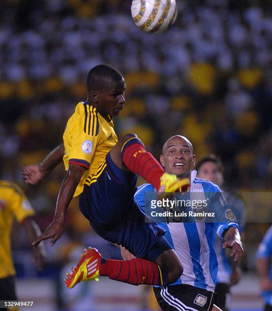 Darwin Quintero, from Colombia, fights for the ball with Clemente Rodriguez, from Argentina, during a match between Colombia and Argentina as part of...