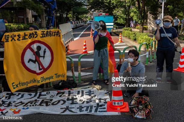 Anti-Olympics protesters demonstrate during the Olympic Torch Relay Celebration event on July 19, 2021 in Tokyo, Japan. As the Olympic torch relay...