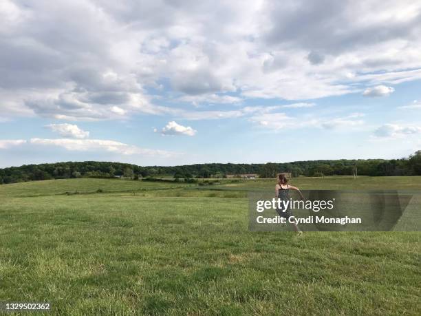 little girl running in an open field - open field stock pictures, royalty-free photos & images