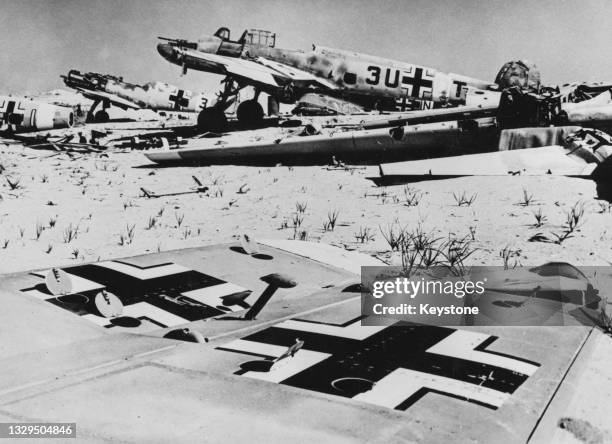 The wreckage of a battle damaged Luftwaffe Messerschmitt Bf 110 C-4 twin engined heavy fighter of Zerstorergeschwader 26 "Horst Wessel" and a...