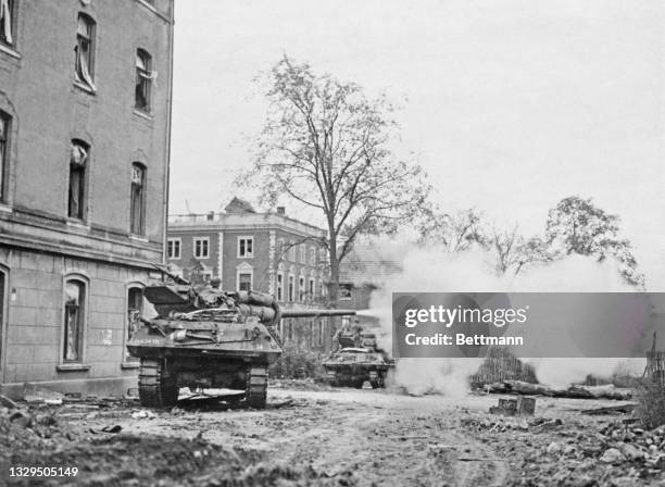 An M-10 tank destroyer from the 634th Tank Destroyer Battalion of the 1st "Big Red One" Infantry Division, United States First Army opens fire on...