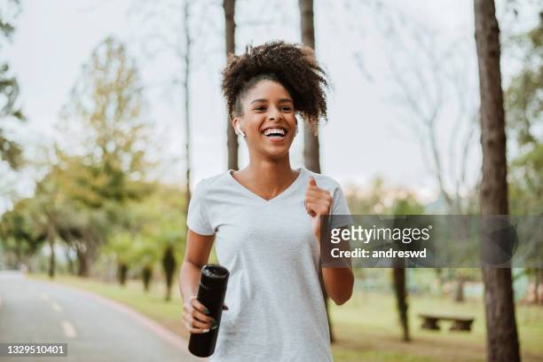 woman running in the park - running stock pictures, royalty-free photos & images