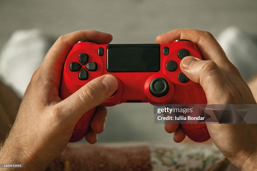 Handsome man holding a gamepad