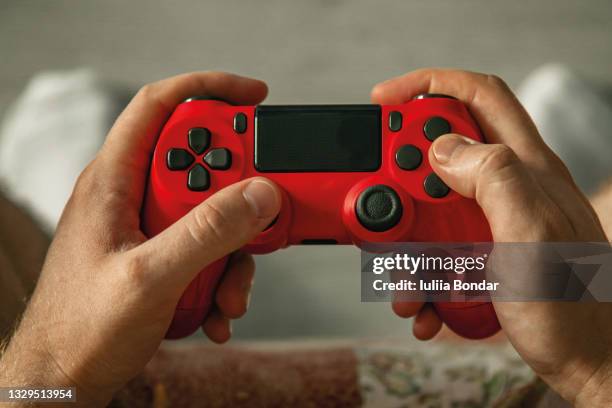 handsome man holding a gamepad - control stockfoto's en -beelden