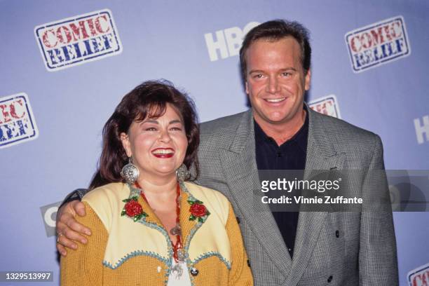 American comedian Roseanne Barr, wearing a yellow Western-style jacket with red floral detail, and her husband, American actor and comedian Tom...