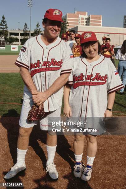 American actor and comedian Tom Arnold and his wife, American comedian Roseanne Barr, both wearing grey-and-red softball kits, attend MTV's 2nd...