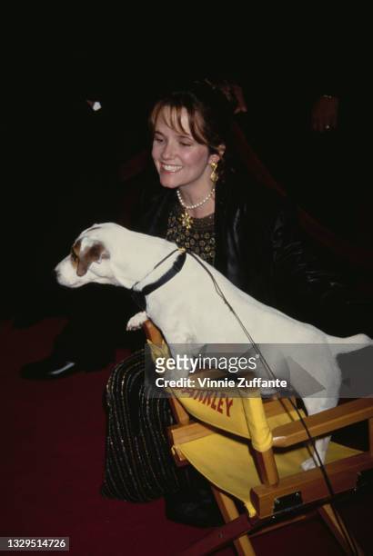 American actress Lea Thompson with Jack Russell terrier Barkley, who stands on a director's chair which bears its name, attends the premiere of...