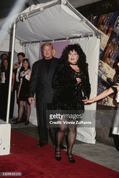 American comedian Roseanne Barr, wearing a black outfit, and her partner, Ben Thomas, attend the 1994 MTV Video Music Awards, held at Radio City...