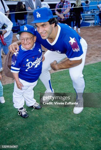 American actor Billy Barty with American actor and bodybuilder Lou Ferrigno, both wearing Dodgers kits, attend Hollywood Stars Night at Dodgers...