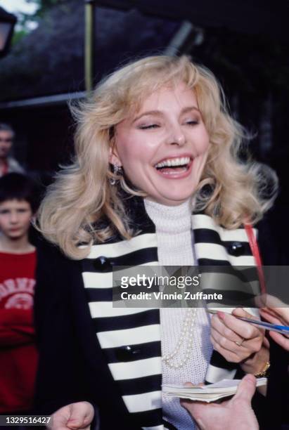 American actress Priscilla Barnes wearing a black jacket with black-and-white striped lapels, location unspecified, circa 1985.