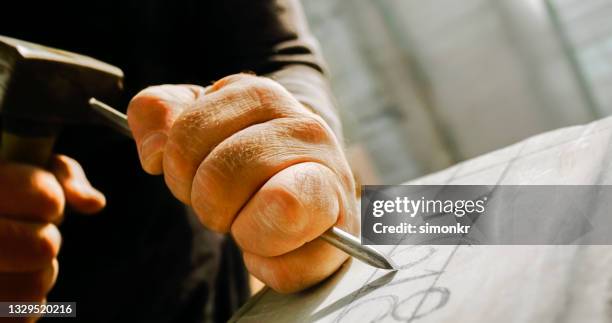 stonemason chiselling numbers on stone - sculptor stock pictures, royalty-free photos & images