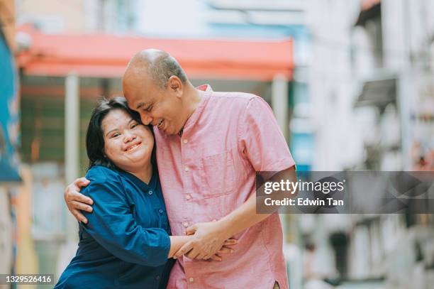 happy asian malay autism down syndrome female  bonding  with her father in city street - autistic adult imagens e fotografias de stock