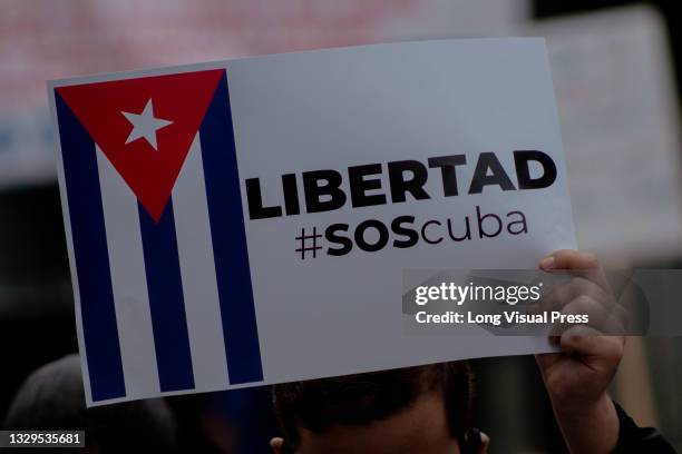 As Cuban residents that live in Colombia protest against the unrest and violence held in the Island against the government of Cuban president Miguel...