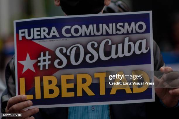 As Cuban residents that live in Colombia protest against the unrest and violence held in the Island against the government of Cuban president Miguel...