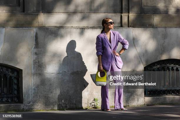 Julia Comil wears a pastel purple lavander linen oversized blazer by Maryam Nassir Zadeh, pastel purple lavander linen high waisted pants by Maryam...