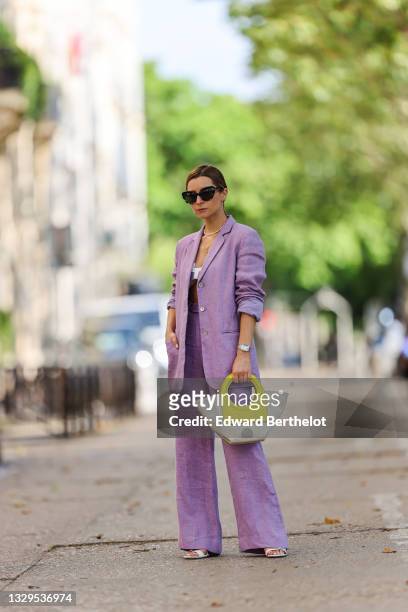 Julia Comil wears a pastel purple lavander linen oversized blazer by Maryam Nassir Zadeh, pastel purple lavander linen high waisted pants by Maryam...