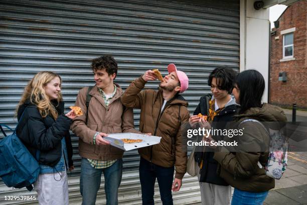 friends enjoying a pizza together - tyne and wear stock pictures, royalty-free photos & images