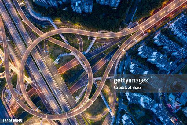 the night view of the urban interchange bridge from the perspective of drones - motorway junction stock pictures, royalty-free photos & images