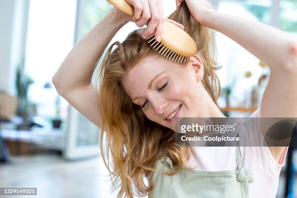 woman with hairbrush from recycled material. - cepillar el cabello fotografías e imágenes de stock