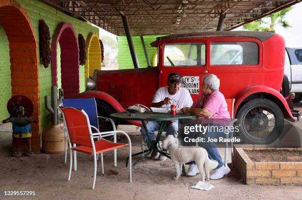 Cody Colchado and Lupe Colchado eat lunch at the Chuy's restaurant as people anticipate Jeff Bezos’ scheduled launch in his Blue Origin rocket from a...