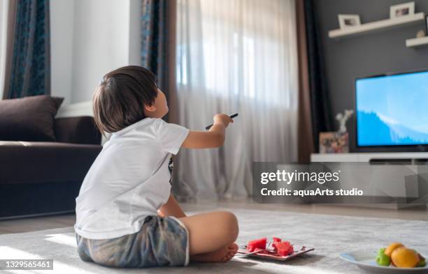 child watching tv at home. - cartoon tv stock pictures, royalty-free photos & images