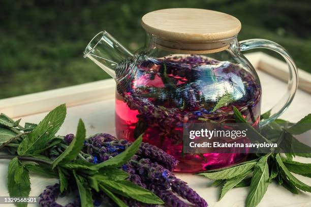 herbal tea with sage in a transparent glass teapot. - ティーポット ストックフォトと画像