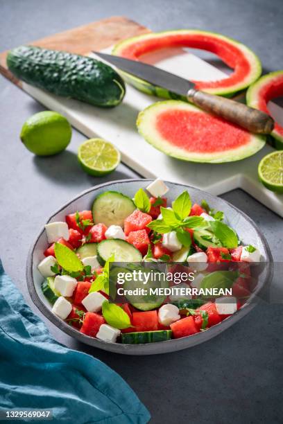 healthy vegetarian watermelon salad bowl with feta cheese, cucumber and parsley - cucumber leaves stock pictures, royalty-free photos & images