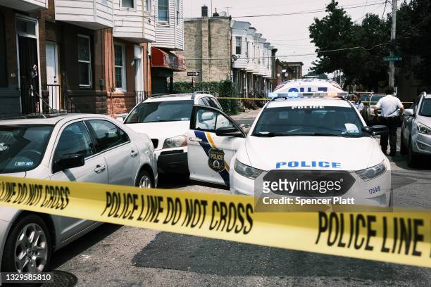 Police tape blocks a street where a person was recently shot in a drug related event in Kensington on July 19, 2021 in Philadelphia, Pennsylvania....