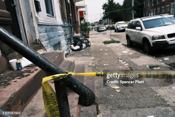 Police tape blocks a street where a person was recently shot in a drug related event in Kensington on July 19, 2021 in Philadelphia, Pennsylvania....