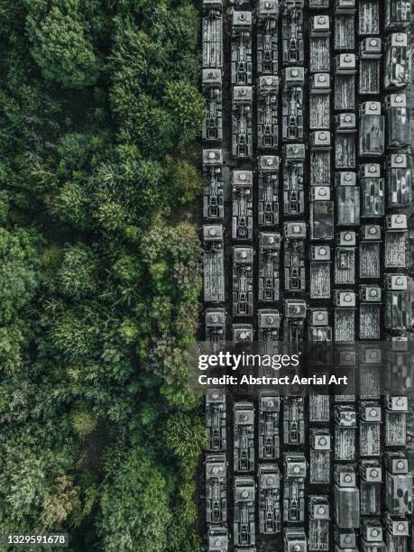 drone shot showing rows of abandoned trucks at the edge of a forest, england, united kingdom - queue system stock pictures, royalty-free photos & images