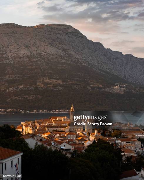 old island town of korčula catches the sunlight at sunset - korcula island stock pictures, royalty-free photos & images