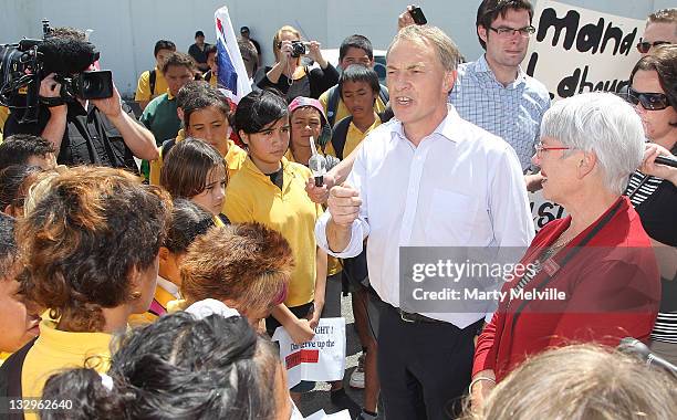 Labour Party leader Phil Goff speaks to young members of Kawerau Intermediate school as they protest to save their school during a campaign visit on...