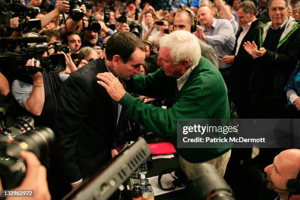 Head coach Mike Krzyzewski of the Duke Blue Devils hugs Bob Knight after winning his 903rd game and passing him to become the all-time winningest...