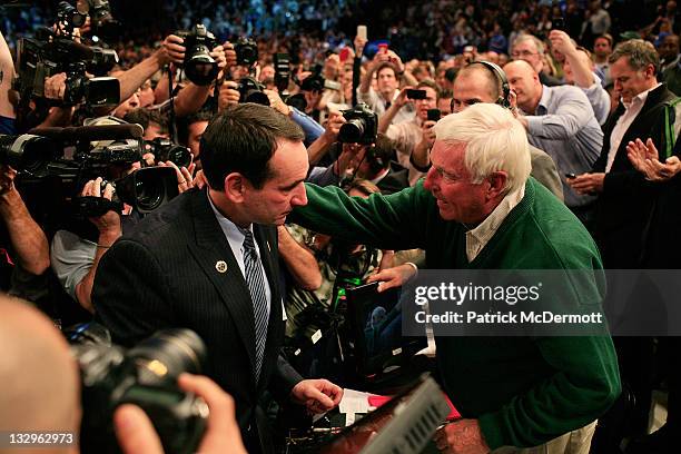 Head coach Mike Krzyzewski of the Duke Blue Devils hugs Bob Knight after winning his 903rd game and passing him to become the all-time winningest...