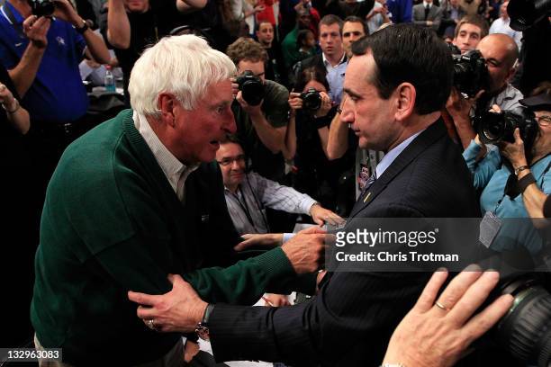 Head coach Mike Krzyzewski of the Duke Blue Devils embraces Bobby Knight after winning his 903 NCAA Division 1 basketball game and becoming the...
