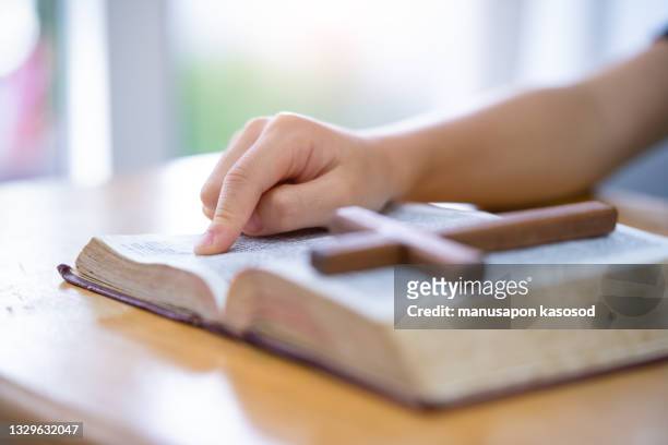 holy bible. - child praying school stock pictures, royalty-free photos & images