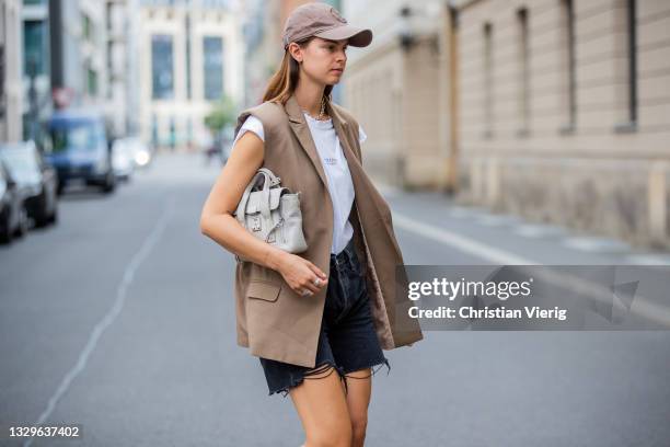 Jacqueline Zelwis is seen wearing Levi’s Shorts, Onweekends T-Shirt, Munthe vest in beige, Marc O’Polo Cap, 3.1 Phillip Lim bag, Asis sneaker on July...