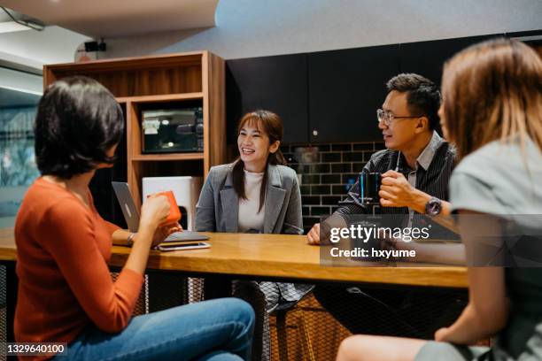 coworkers relaxing in office pantry for coffee break - ice breaking stock pictures, royalty-free photos & images