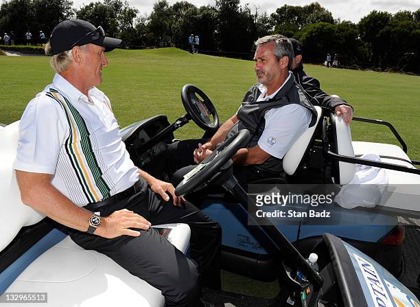 International Team captain Greg Norman chats with co-assistent captains Frank Nobilo and Tim Clark on the eighth hole during practice for The...