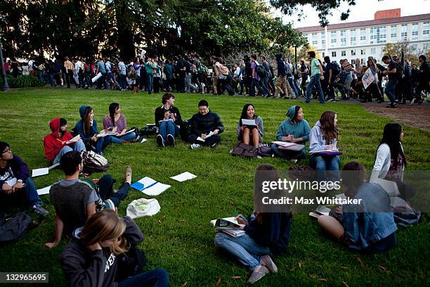 University of California, Berkeley students hold a "teach-out" as other students march through campus as part of an "open university" strike in...