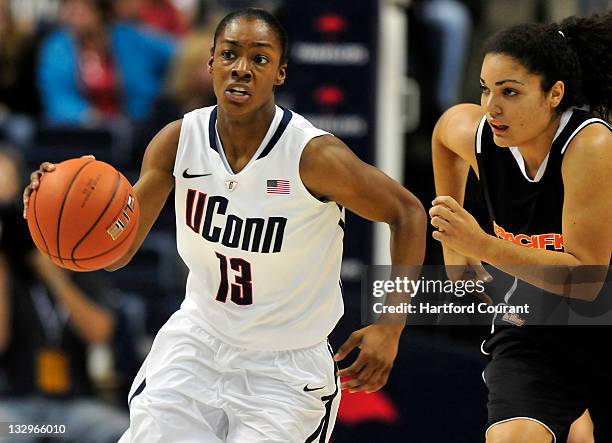 Brianna Banks of Connecticut pushes the ball up court after getting a loose ball from Brianna Johnson of Pacific at Gampel Pavilion in Storrs,...