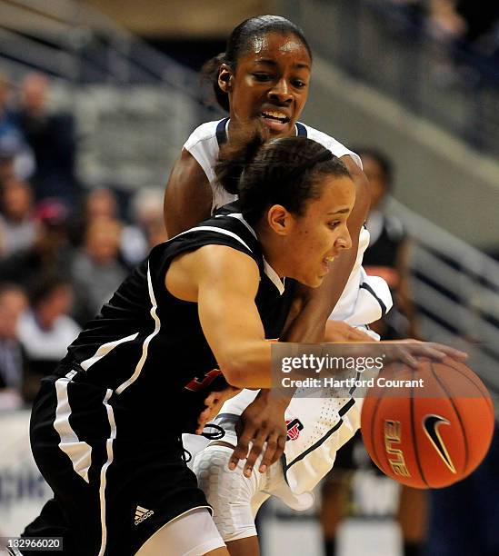 Brianna Banks of Connecticut tries to steal the ball from Kristina Johnson Pacific at Gampel Pavilion in Storrs, Connecticut, on Tuesday, November...