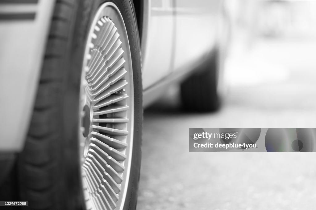 Parked car with focus on the right rim and rear wheel