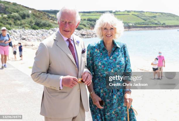 Prince Charles, Prince of Wales and Camilla, Duchess of Cornwall smile as they visit Porthcressa Beach during Day 2 of their visit to Devon and...