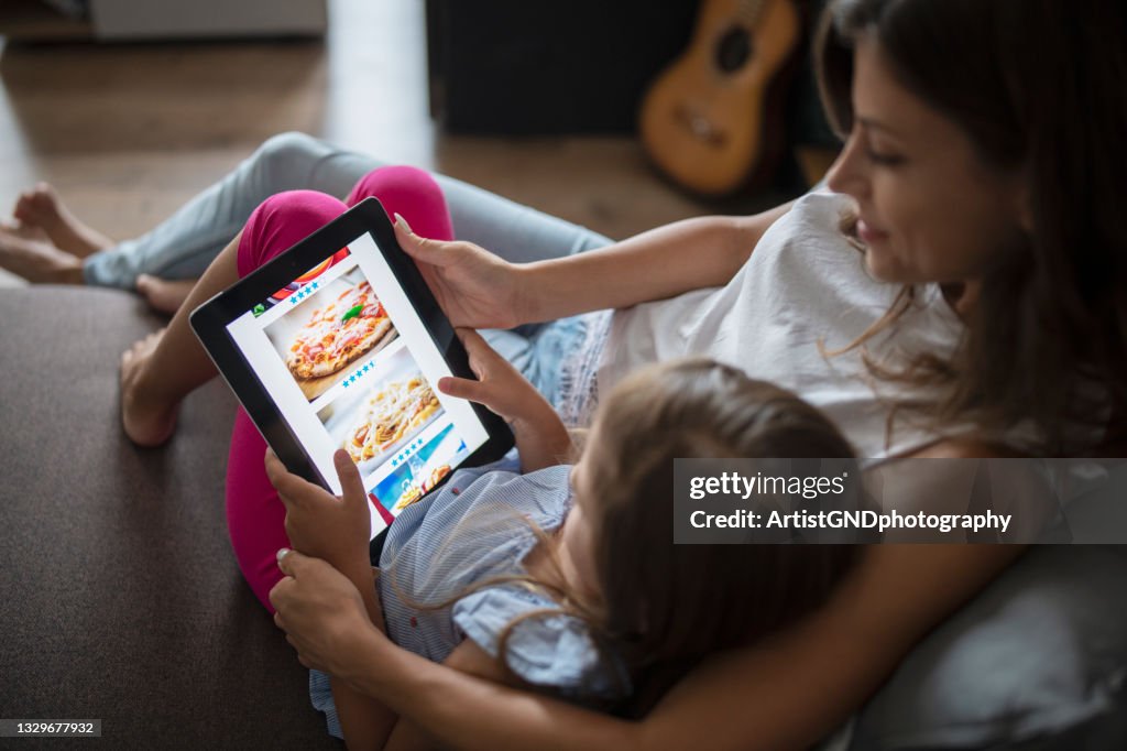 Ordering food online by a beautiful young family