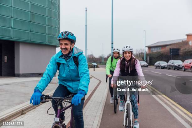 getting there by bike - active seniors biking stock pictures, royalty-free photos & images