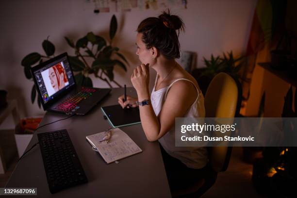 creative female digital artist, creating an amazing design, while working late from her home office - photoshop stock pictures, royalty-free photos & images