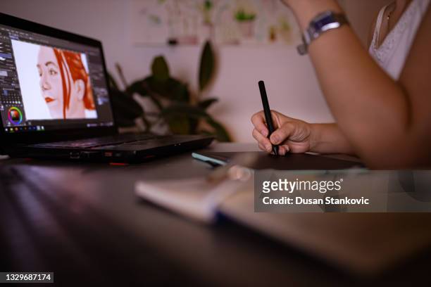 curious female digital art student, learning new illustration techniques, late at night from her home office - graphic designer bildbanksfoton och bilder
