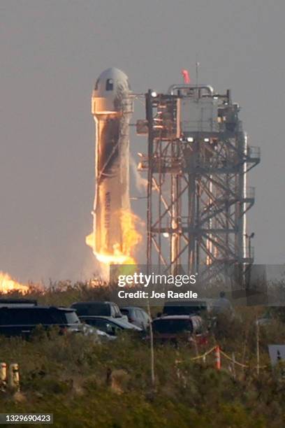 The New Shepard Blue Origin rocket lifts-off from the launch pad carrying Jeff Bezos along with his brother Mark Bezos, 18-year-old Oliver Daemen,...